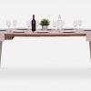 Small grey wooden dining table with place settings for 8 people