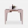 Small grey wooden dining table with place settings for 4 people