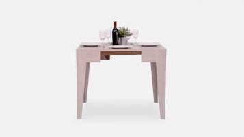 Small grey wooden dining table with place settings for 4 people