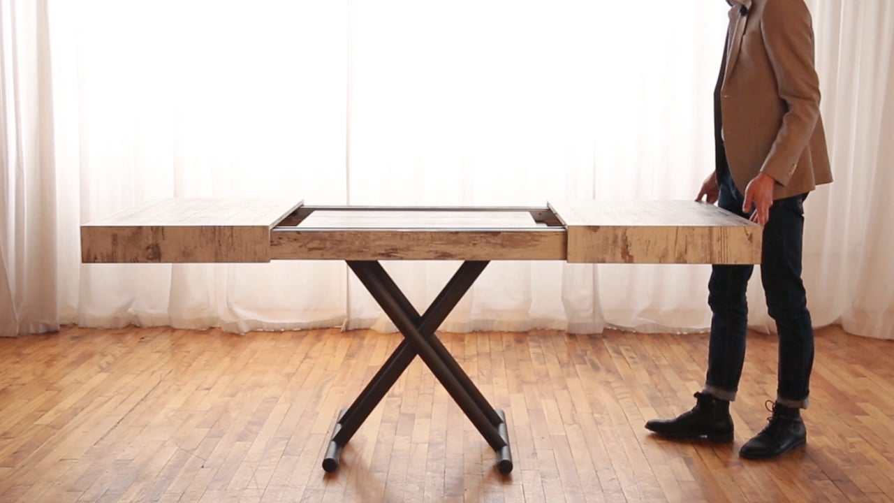 Man closing a table with built in extensions